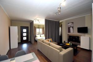 a living room with a couch and a table at Potamos Studios by GERANI in Órmos