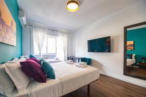 a bedroom with a large bed with colorful pillows at My Vatican Place in Rome