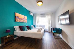 a bedroom with a large bed with blue walls at My Vatican Place in Rome