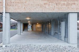 an empty hallway of a building with glass doors at BOUTIQUE APARTMENTS LUSTENAU Nachhaltige Kühlung über Erdsonde und Fussbodenkühlung in Lustenau