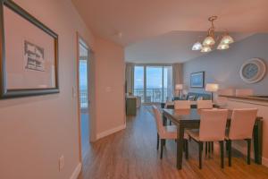 a dining room and living room with a table and chairs at Huge Ocean Front Condo, Amazing Views in Myrtle Beach
