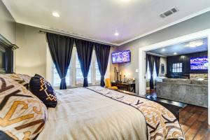 a bedroom with a large bed and a television at Central Home 1 Mi to Texas Tech and by Dtwn Lubbock in Lubbock