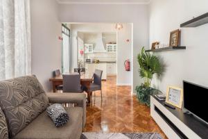 a living room with a couch and a dining room at Home Away From Home in Caniçal