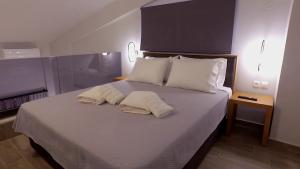 Postel nebo postele na pokoji v ubytování Perla Inn
