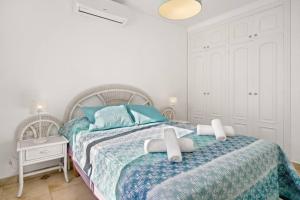 a bedroom with a bed with two crosses on it at Villa Atalis in Son Bou
