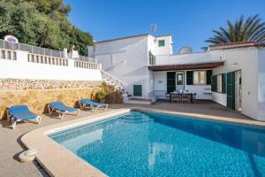 a villa with a swimming pool and a house at Villa Atalis in Son Bou +32 photos