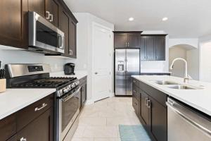 a kitchen with brown cabinets and a stainless steel refrigerator at A Vacation Vista home in Washington