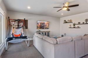 a living room with a couch and a ceiling fan at Adventure Awaits #81 townhouse in Santa Clara