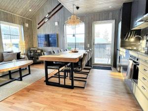 a kitchen and dining room with a dining table in a room at Holiday home SÄLEN XXIX in Stöten