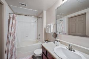 a bathroom with a sink and a tub and a toilet at HEIRS VENTURES: Fantasy . Near DT . WiFi . King Bed . W/D . 55” TV in Oklahoma City