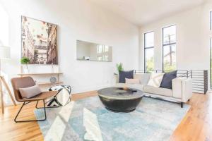 a living room with a couch and a coffee table at Glamorous Perfectly Located Luxury 2 Bed Townhome in Dallas