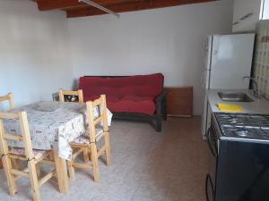cocina con mesa, sillas y nevera en Alquileres patagonicos en San Carlos de Bariloche