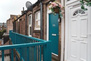 a blue door on a row of houses at 1 bedroom flat with easy parking/public transport in Dundee