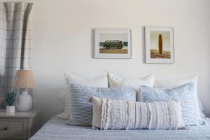 a bedroom with a bed with blue and white pillows at 9 Palms in Myrtle Beach