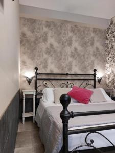 a bedroom with a bed with red pillows on it at Sweet Home & Wellness Luxury Apartment in Nettuno +5 photos
