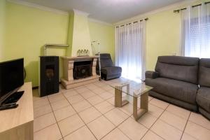een woonkamer met een bank en een open haard bij Aveiro Cozy Apartment in Eixo