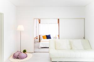 a white living room with a white couch and a bed at Takashima - House - Vacation STAY 68992v in Takashima