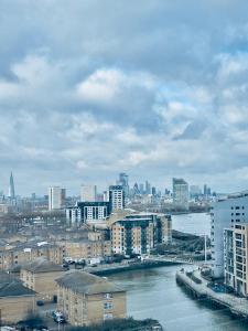 a view of a city with a river and buildings at Greenwich Luxury View Apartment in London