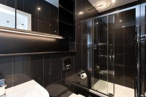 a bathroom with a glass shower and a sink at Pillo Rooms Serviced Apartments - Manchester Arena in Manchester