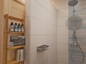 a bathroom with a shower with a glass door at Ferienhaus am Seeblick Grill, Garten, Billiard, Dart, Bike, Sauna ww-Seeblick in Driedorf +34 photos