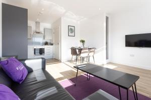 a living room with a couch and a table at Pillo Rooms Serviced Apartments - Manchester Arena in Manchester