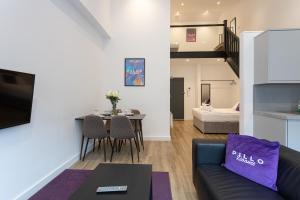 a living room with a couch and a table at Pillo Rooms Serviced Apartments - Manchester Arena in Manchester
