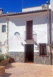 a house with a mural on the side of it at Casa Rural Torrecilla, 1919 in Yunquera