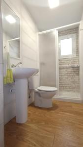 a bathroom with a sink and a toilet and a window at Casa Rural Torrecilla, 1919 in Yunquera +20 photos