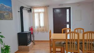 a kitchen and dining room with a table and a television at Casa Rural Torrecilla, 1919 in Yunquera