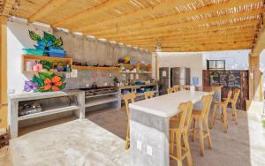 a kitchen with a table and chairs in a room at SurfNest Hostel in Brisas de Zicatela