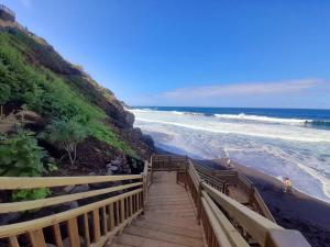 a staircase leading down to a beach with the ocean at Casa Vistazul in La Orotava