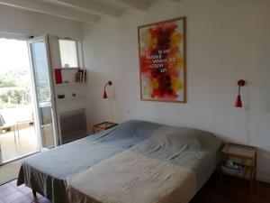 a bedroom with a bed and a picture on the wall at Mont-Ventoux, Provence, Appartement avec vue panoramique et piscine in Mollans-sur-Ouvèze +199 photos