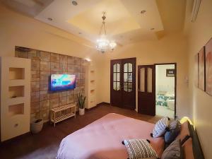 a bedroom with a bed and a tv on a wall at Michi House Giang Văn Minh đối diện Bảo tàng HCM in Hanoi