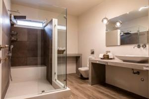 a bathroom with a glass shower and a sink at Heaven's Hill in Naxos Chora