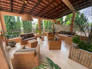 an outdoor patio with wicker furniture and plants at Nomads in Lomé
