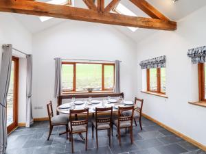 a dining room with a table and chairs at Cwmwr in Pen-y-bont-fawr