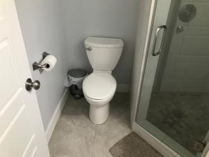 a white toilet in a bathroom with a shower at Sweet Dreams in South Jordan