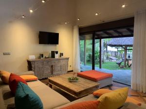 a living room with a couch and a table at Villa Mbolatsara in Nosy Be