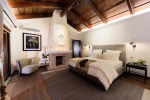 a bedroom with a large bed and a fireplace at Villa Las Mil Flores in Antigua Guatemala