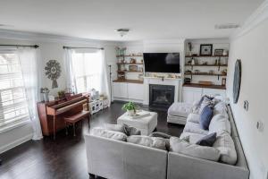 a living room with two couches and a piano at Charming 5 Bedroom spacious Home (sleeps 12-14) in Piedmont