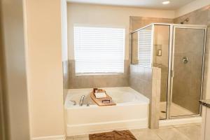 a white bathroom with a tub and a shower at Charming 5 Bedroom spacious Home (sleeps 12-14) in Piedmont +23 photos