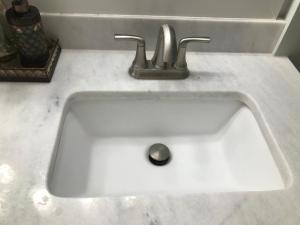 a white sink with two faucets on a counter at Sweet Dreams in South Jordan