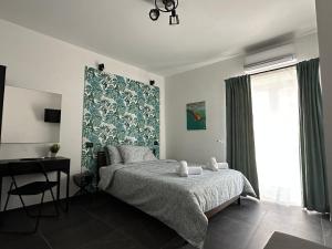 a bedroom with a bed and a large window at Olinad rooms in Castelbuono