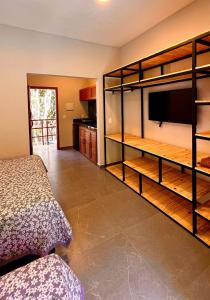 a bedroom with a bed and a flat screen tv at Pousada Pipa Soul in Pipa
