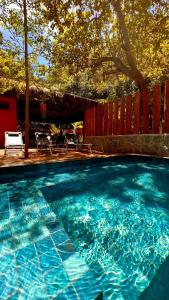 a large swimming pool with blue water in a yard at Pousada Pipa Soul in Pipa