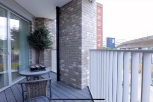 a balcony with a table and a bench on it at Luxury 1 bedroom East London in London