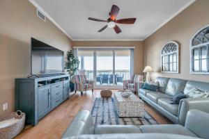 a living room with a couch and a ceiling fan at 3 bed 3 bath Waterfront Condo in Gated Community in St Pete Beach