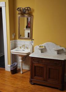 a bathroom with a sink and a mirror at Oaklawn Inn in Menomonie