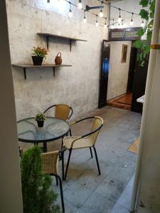 a patio with two tables and chairs and lights at Hermoso departamento en el centro ciudad, casa M MELGAR in Arequipa