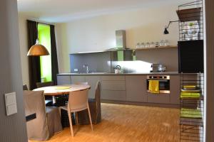 a kitchen with a table and a dining room at My Home in Vienna - Smart Apartments - Landstraße in Vienna